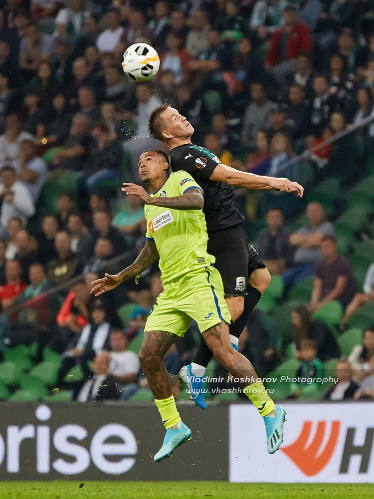 Sergey Petrov of FC Krasnodar battle for the ball with Robert Ke